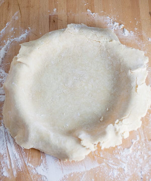 Unbaked homemade pie crust in pie pan.