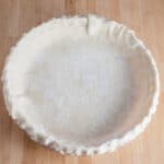 Trimmed unbaked pie dough in pie pan.