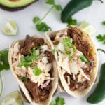 Barbacoa tacos with chipotle slaw, avocado, fresh cilantro, and jalapeno peppers.