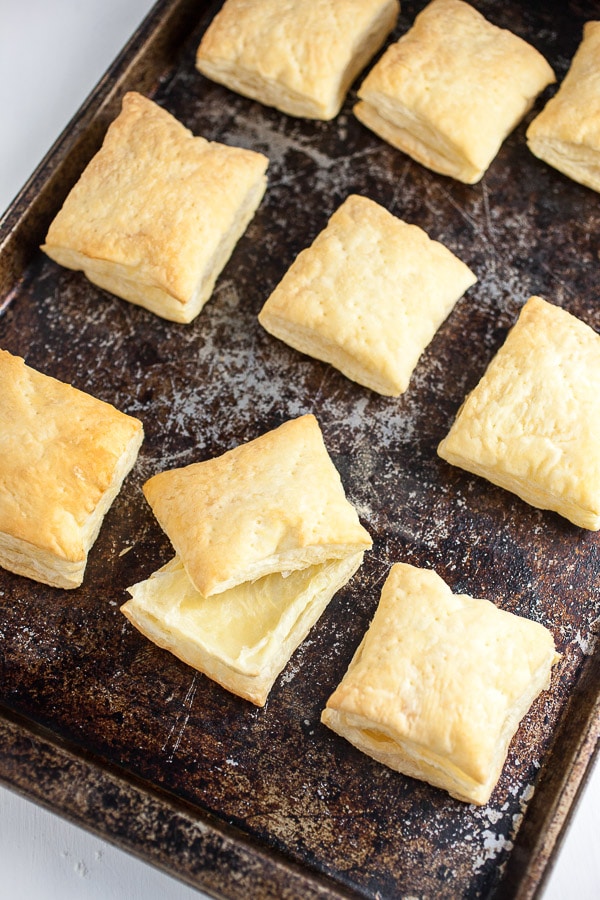 Baked Puff Pastry squares on baking sheet.