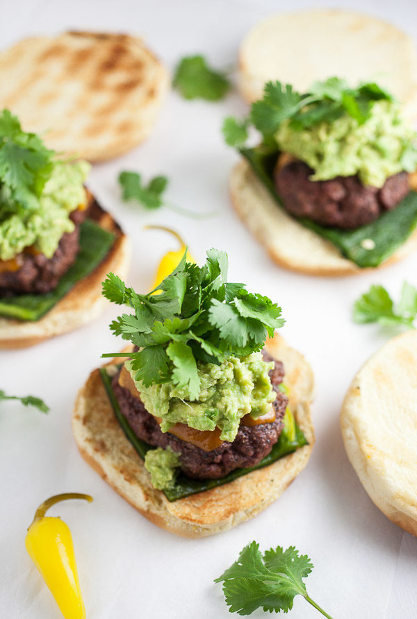 Grilled burgers with roasted poblano peppers, avocado guacamole, and fresh cilantro.