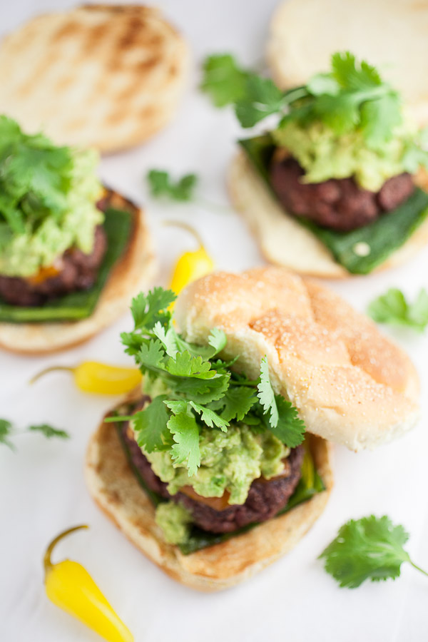 Poblano burgers on buns with avocado guacamole and fresh cilantro.