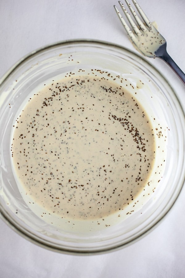 Coleslaw dressing in small glass bowl with fork.