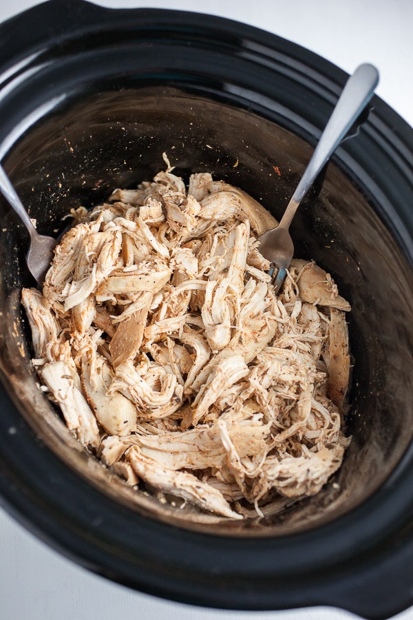 Shredded cooked chicken in slow cooker.