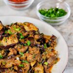 Moroccan eggplant salad with chermoula on white serving platter.