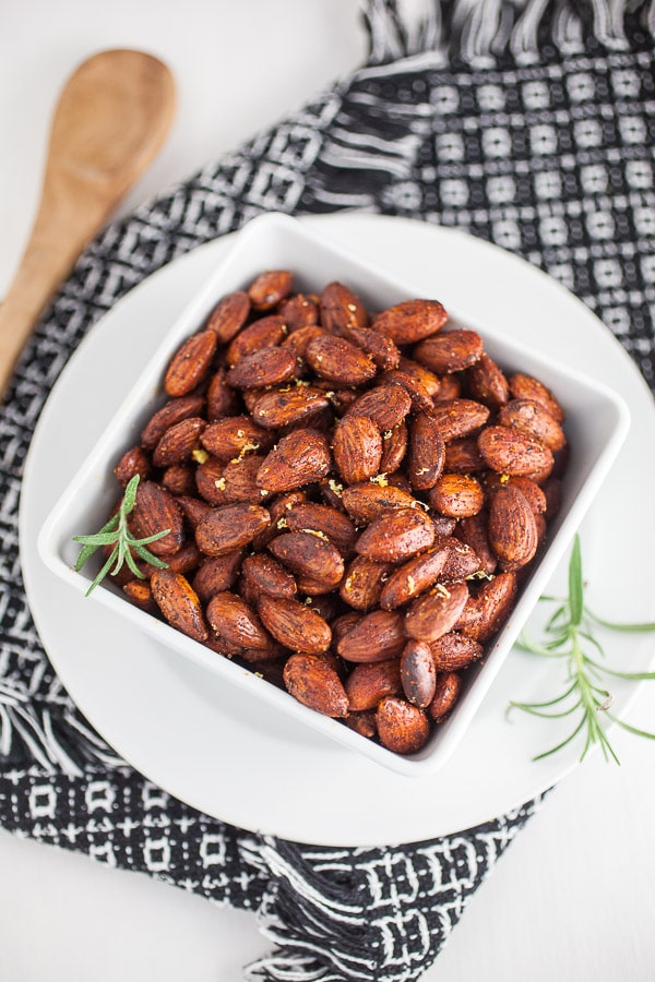 Rosemary roasted almonds in serving bowl on towel.