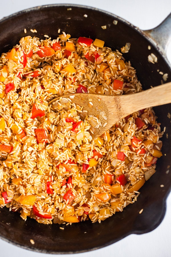 Sautéed garlic, onions, bell peppers, rice, and spices in cast iron Dutch oven. 