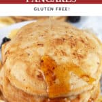 Maple syrup on top of banana cinnamon pancakes on white plate.