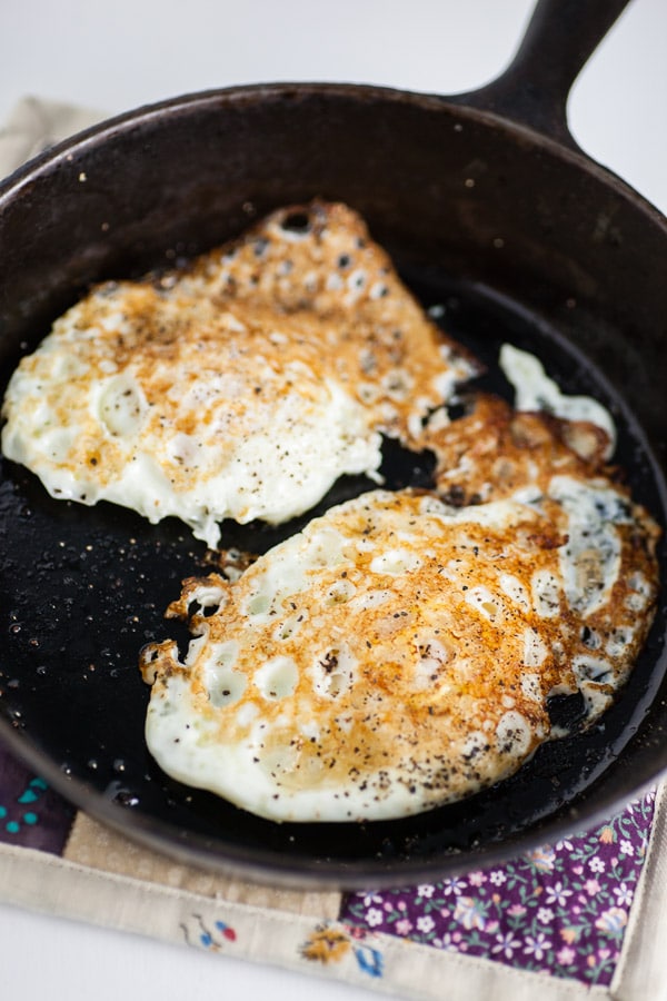 Fried eggs in small cast iron skillet.
