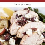 Sheet pan Greek chicken with potatoes, green beans, Kalamata olives, feta cheese, and lemon wedge in white bowl.