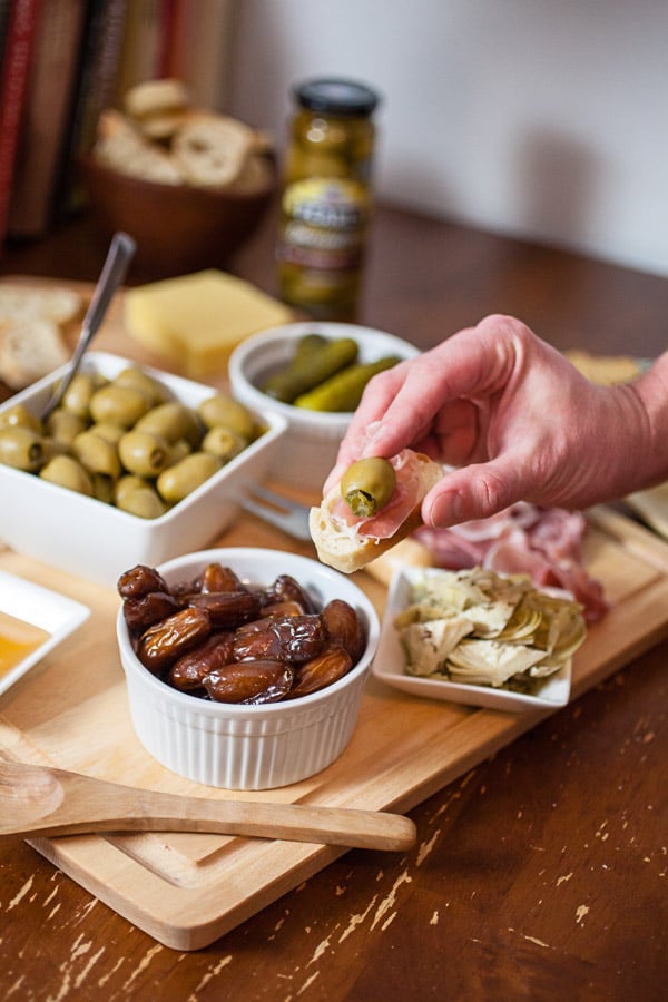 #AD This Simple Spring Antipasto Platter is so easy to assemble and is perfect for spring entertaining! The Italian antipasto platter is a recipe that's full of snacks and appetizers for a crowd. It's great for a party, holidays like Easter, weddings, bridal and baby showers, and graduations. Learn how to make a rustic antipasto platter with meat, cheese, artichokes, olives, and veggies for your next get-together. @PearlsOlives #OlivePearlsEaster #antipasto #easter #appetizer #Italian Simple Spring Antipasto Platter