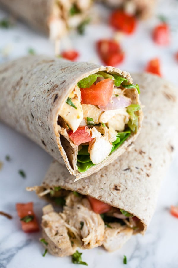 Lemon tarragon chicken salad wraps with diced tomatoes.