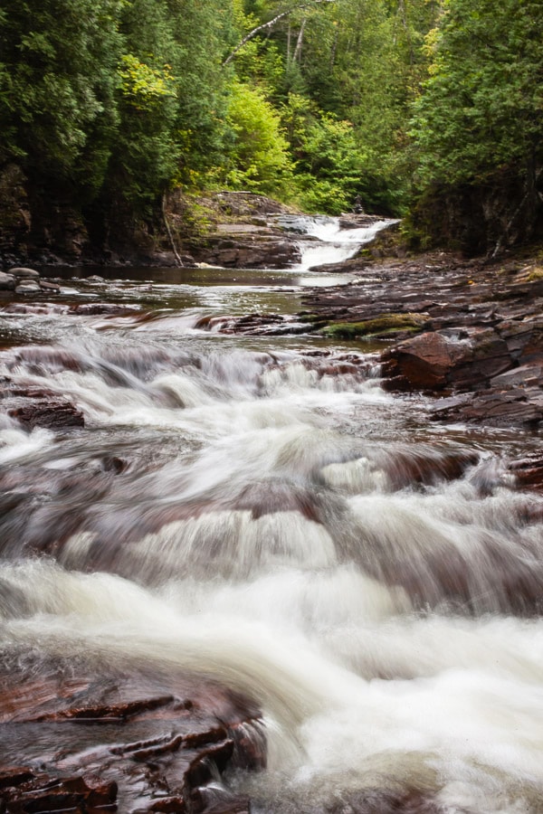 Water running in river through the woods.