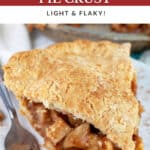 Slice of gluten free apple pie on white plate with fork.