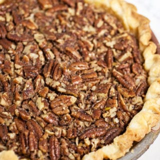 Maple bourbon pecan pie in ceramic pie dish.