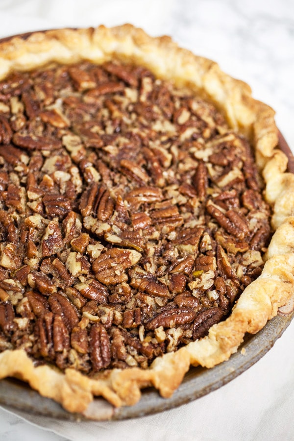 Maple bourbon pecan pie in ceramic pie dish.