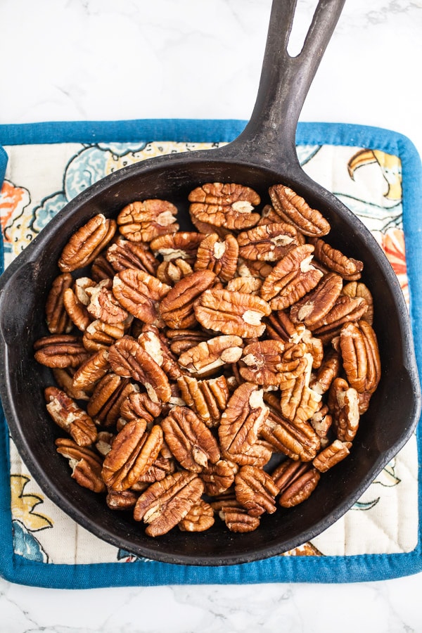 Toasted pecans in small cast iron skillet.