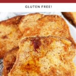 Eggnog French toast on white plate with fork.