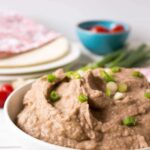Refried Beans With Scallions In White Bowl