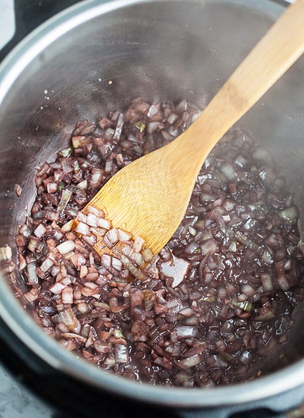 Garlic, onions, and red wine sautéed in Instant Pot.