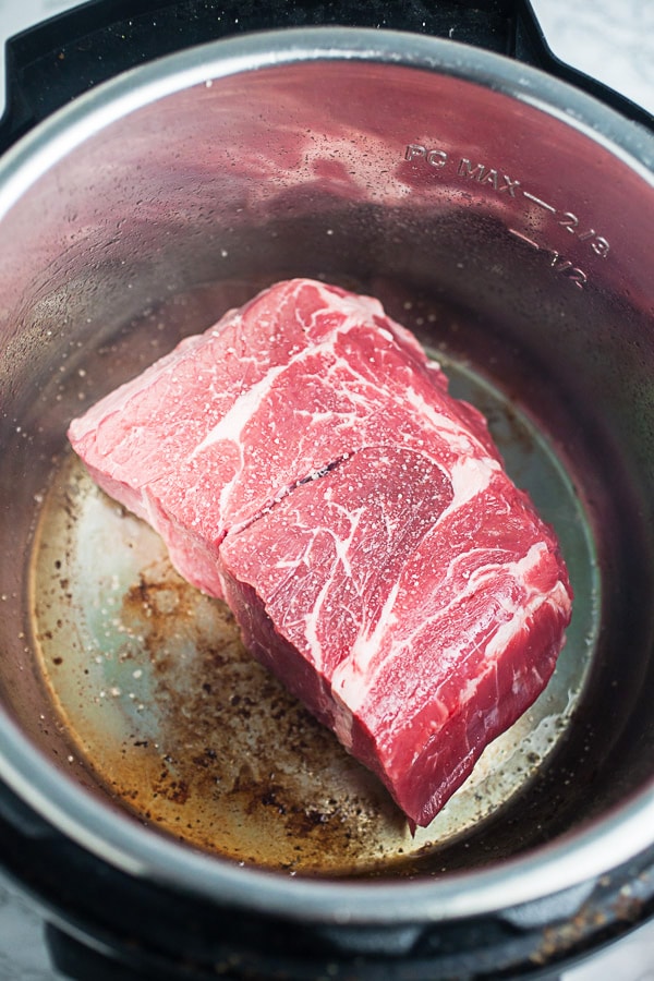 Raw beef chuck roast seared in Instant Pot.
