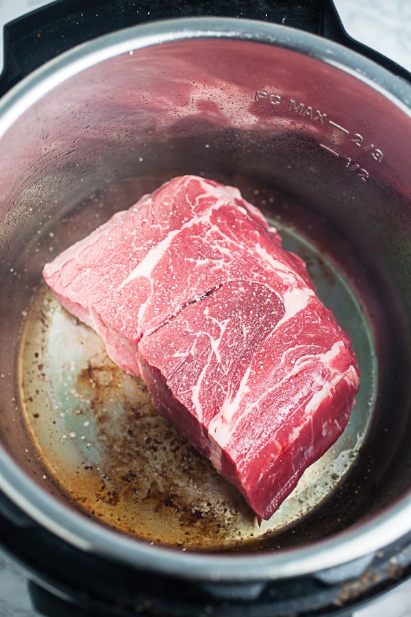 Raw chuck roast seared in Instant Pot.