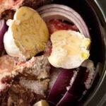 Ingredients For Bone Broth In Black Slow Cooker