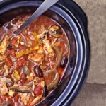Shredded Chicken and Olives In Tomato Broth In Black Slow Cooker