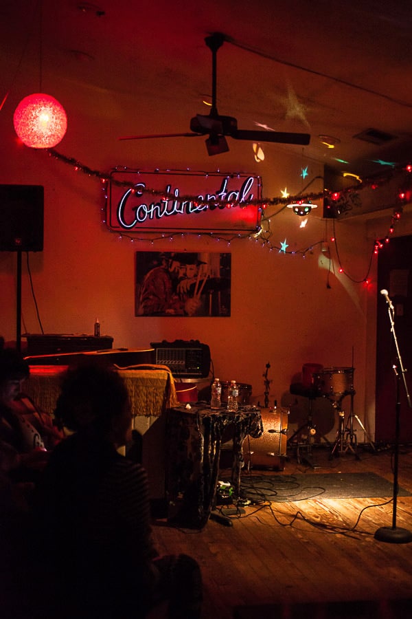 Small stage in dimly lit bar room.