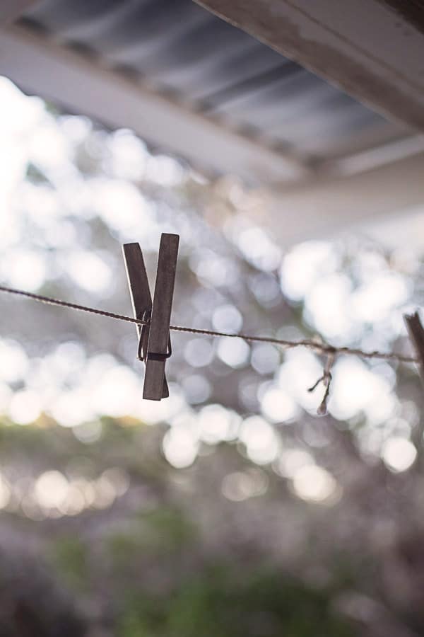 Wooden clothespin on string.