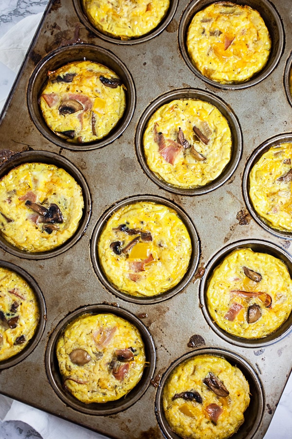 Baked egg cups in metal muffin tin.