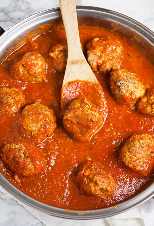 Turkey meatballs cooked in marinara sauce in skillet.