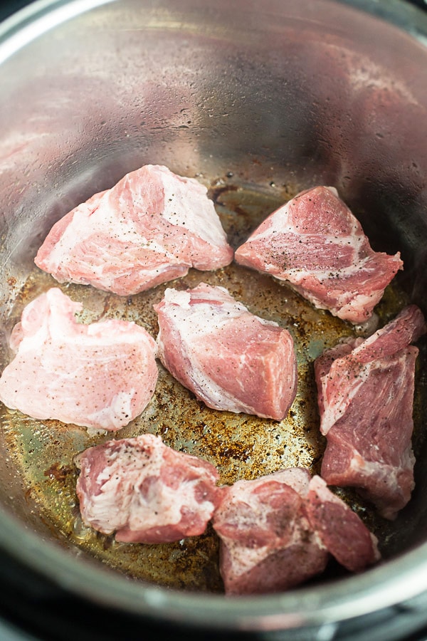 Chunks of pork shoulder sautéed in Instant Pot.