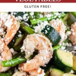 Mediterranean shrimp, asparagus, zucchini, feta cheese, and lemon wedges.