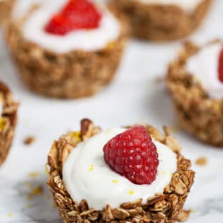 Baked oatmeal cups with Greek yogurt topped with fresh raspberries.