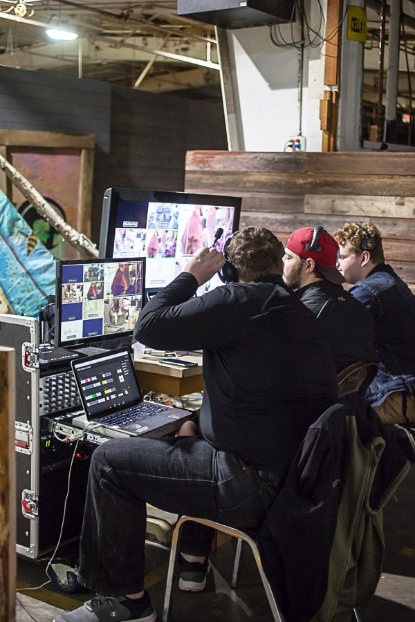 Editors working behind the scenes in front of monitors.