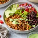 Southwest chicken bowls drizzled with avocado dressing.