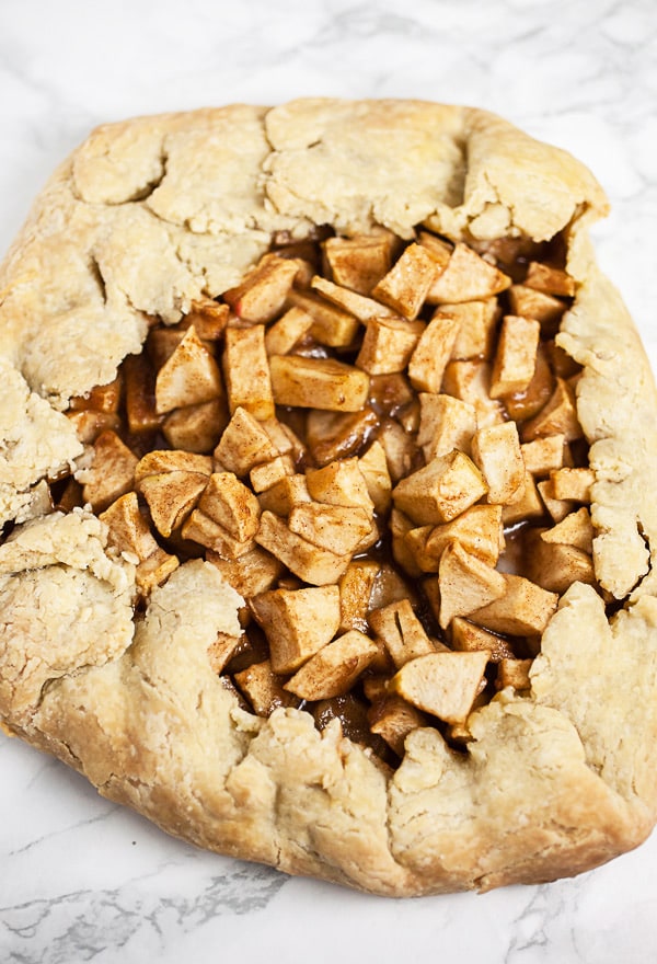 Baked apple galette on white surface.