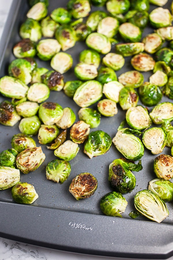 Roasted Brussels sprouts on metal baking sheet.