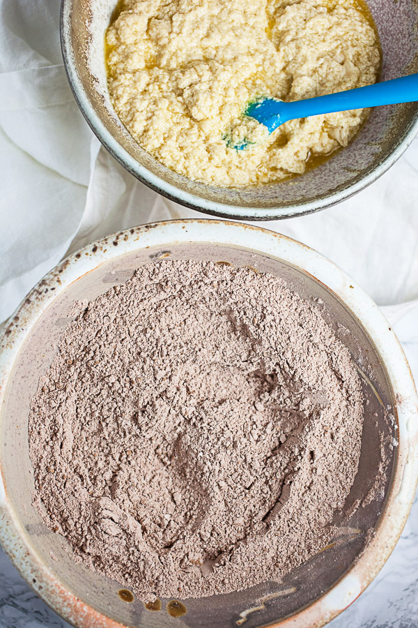 Wet and dry cookie ingredients in two separate ceramic bowls.