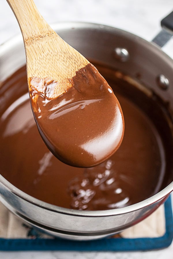 Spoonful of melted chocolate peanut butter mixture lifted from double boiler.