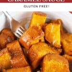 Pumpkin bread pudding with caramel sauce in white bowl with spoon.