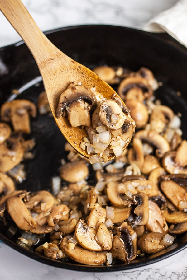 Garlic, onions, and sliced mushrooms sautéed in cast iron skillet.