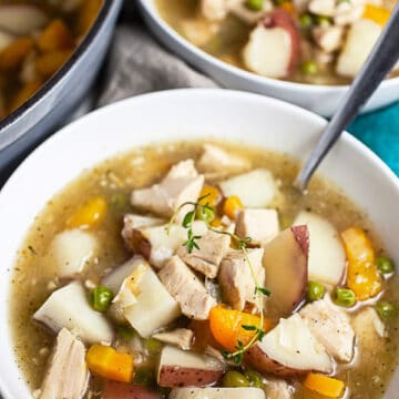 Turkey stew in white bowls with spoons.
