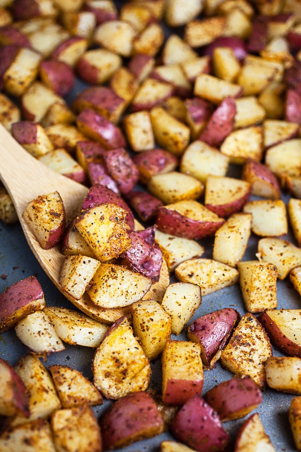 Cooked red potatoes on baking sheet.