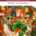 Scoop of Tuscan vegetable soup lifted from Dutch oven on metal ladle.