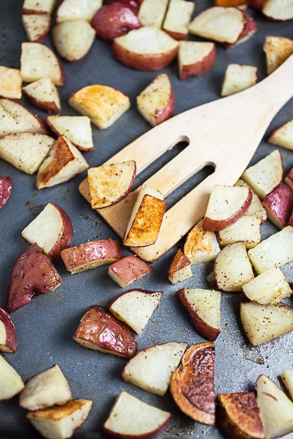 Roasted potatoes on metal baking sheet.