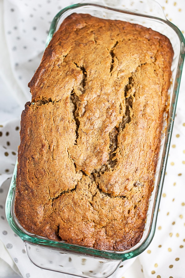 Baked banana bread in glass bread pan.