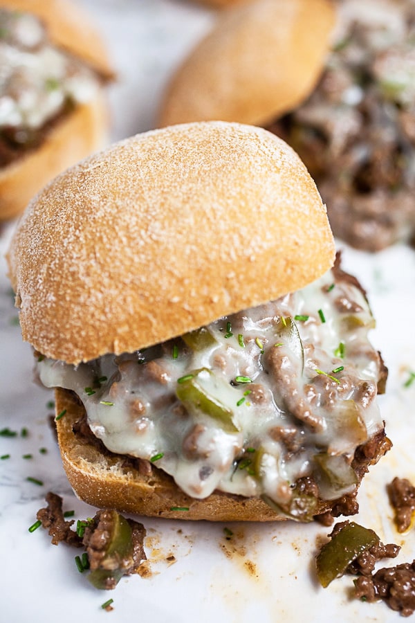 Philly cheesesteak sloppy joes with melted cheese on buns.