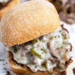 Philly cheesesteak sloppy joes with melted cheese on buns.